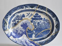 Paul Scott, "Scott's Cumbrian Blue(s), Fukushima No: 5," 2015, glaze, decal, c. 1965 Japanese Willow platter, brass pins, gold leaf, tile cement, epoxy resin, 14 x 18.75 x 2".